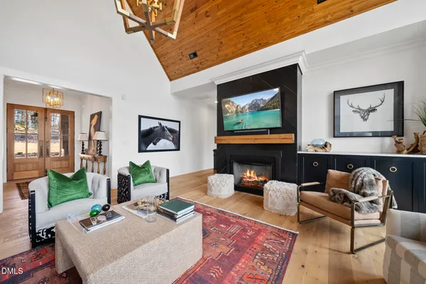 a living room with furniture a fireplace and a flat screen tv