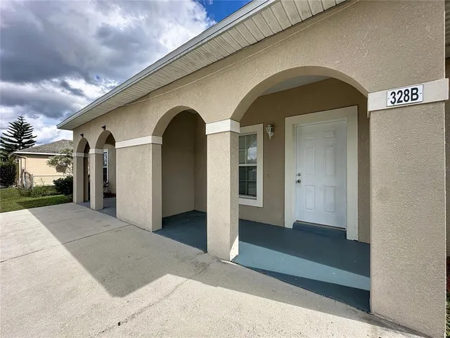 a large kitchen with a stove top oven a sink a counter space and cabinets