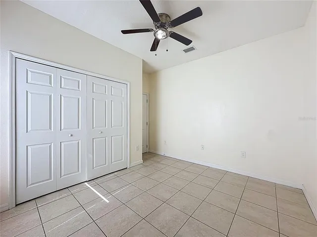 a view of a kitchen with wooden cabinet and a ceiling fan