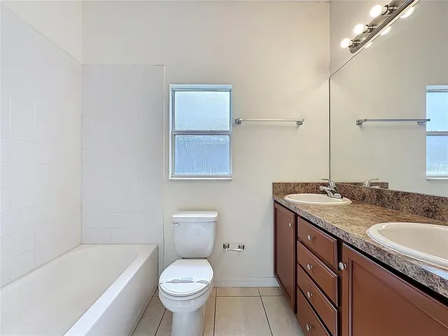 an aerial view of a house with a garden swimming pool and outdoor seating