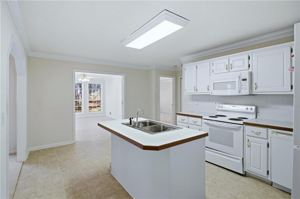 190 Cambridge Way Covington, GA 30016 - Photo 13 of 51 a white kitchen with sink and cabinets