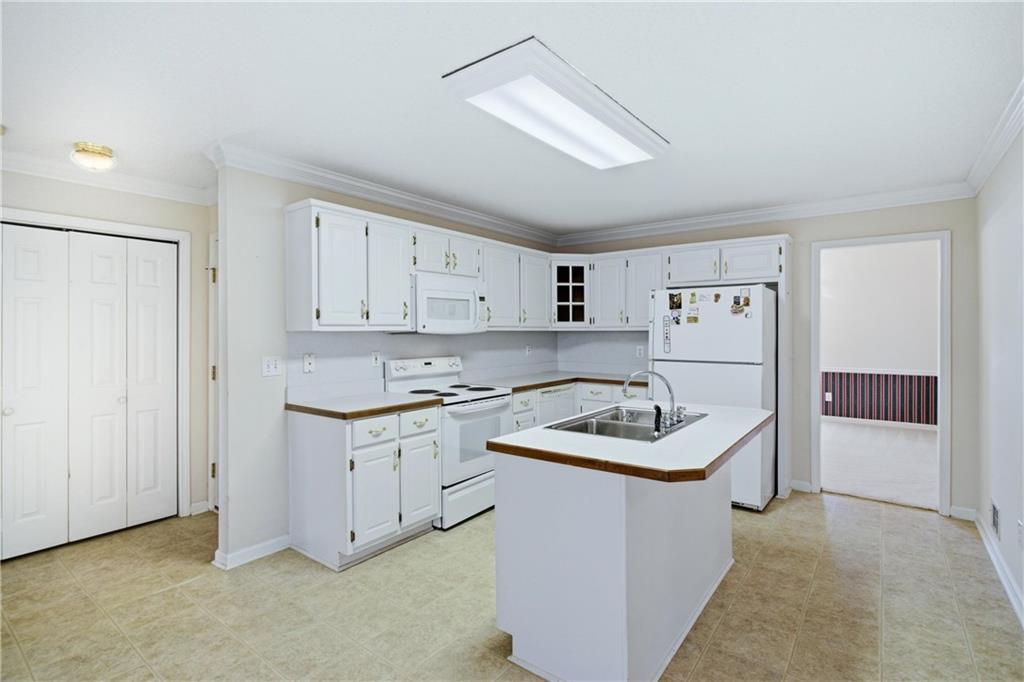 190 Cambridge Way Covington, GA 30016 - Photo 14 of 51 a kitchen with white cabinets and a stove