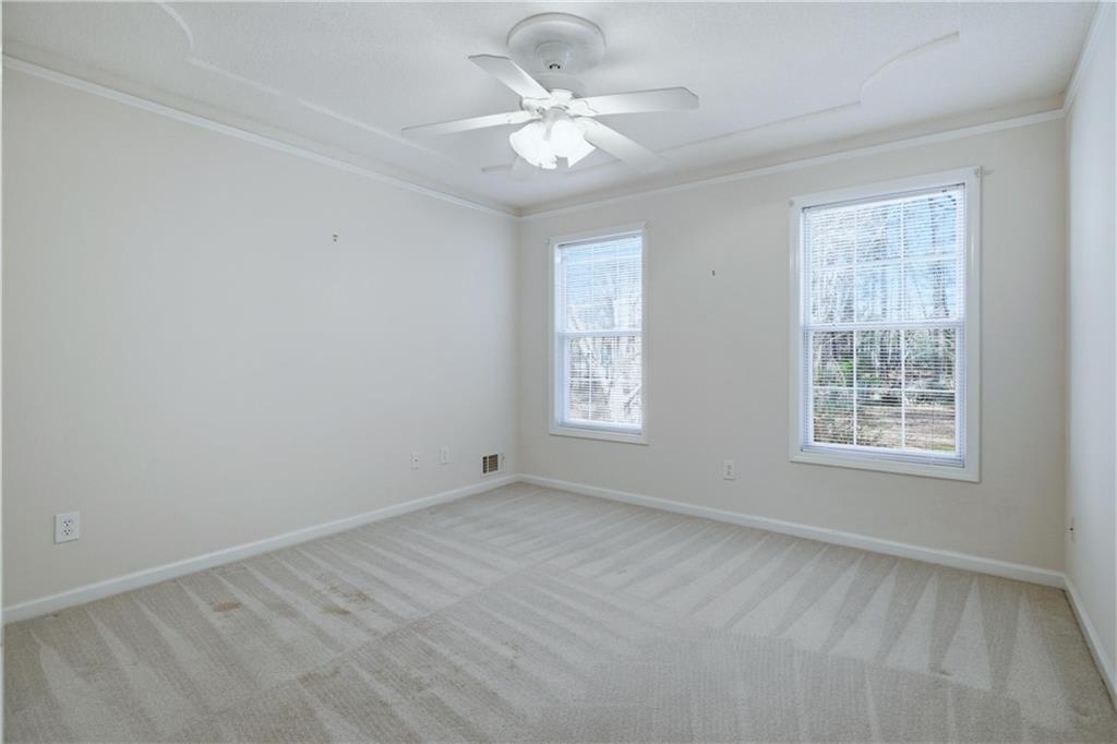 190 Cambridge Way Covington, GA 30016 - Photo 26 of 51 an empty room with windows and ceiling fan