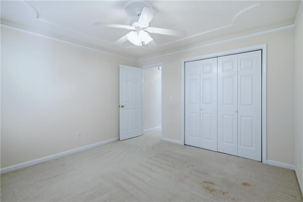 190 Cambridge Way Covington, GA 30016 - Photo 27 of 51 an empty room with a ceiling fan and a window