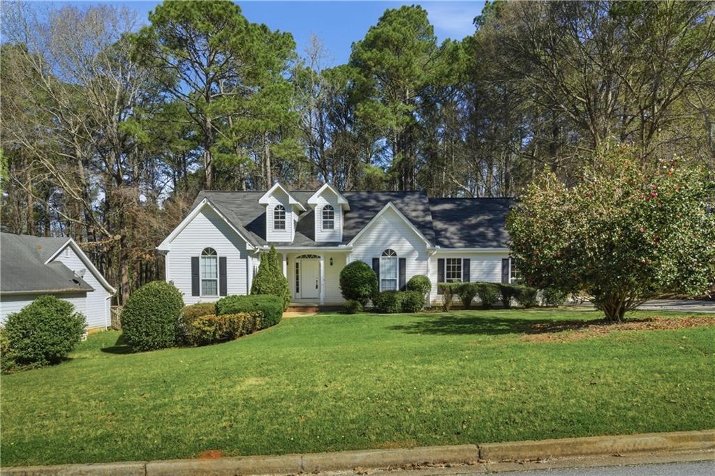 190 Cambridge Way Covington, GA 30016 - Photo 4 of 51 a front view of a house with a garden