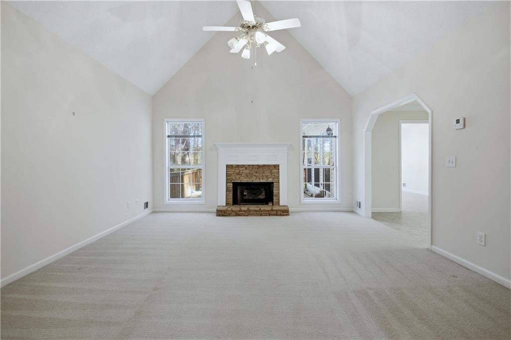 190 Cambridge Way Covington, GA 30016 - Photo 8 of 51 an empty room with windows and fireplace