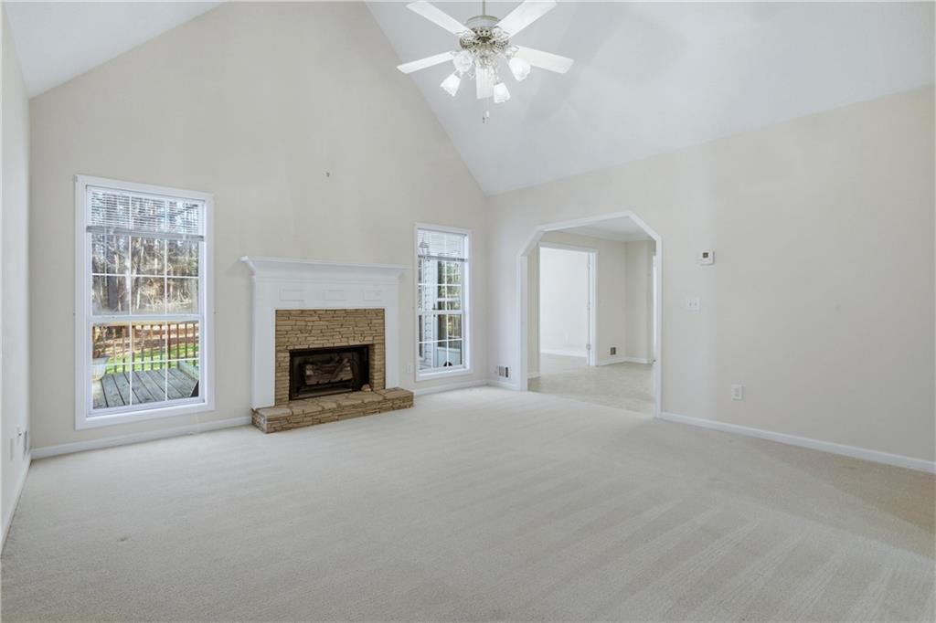 190 Cambridge Way Covington, GA 30016 - Photo 9 of 51 a view of an empty room with a fireplace and a window