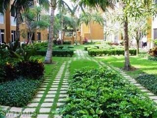 221 9th Street South, Unit 224 Naples, FL 34102 - Photo 5 of 8 a view of backyard of house with green space
