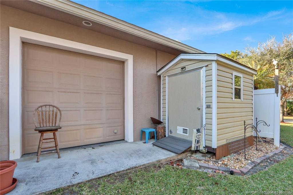 757 Southeast Ashley Oaks Way Stuart, FL 34997 - Photo 59 of 59 back garage door with shed
