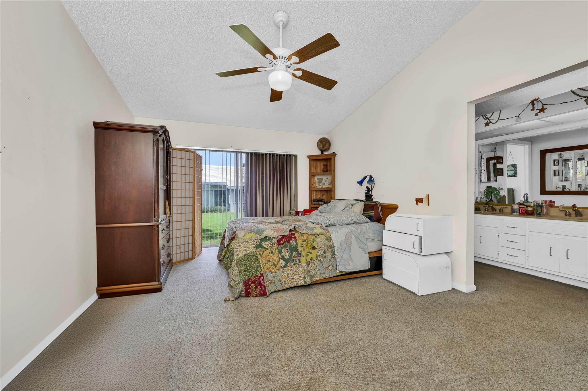 22349 Treetop Circle Boca Raton, FL 33433 - Photo 13 of 36 a bed room with a bed and a ceiling fan