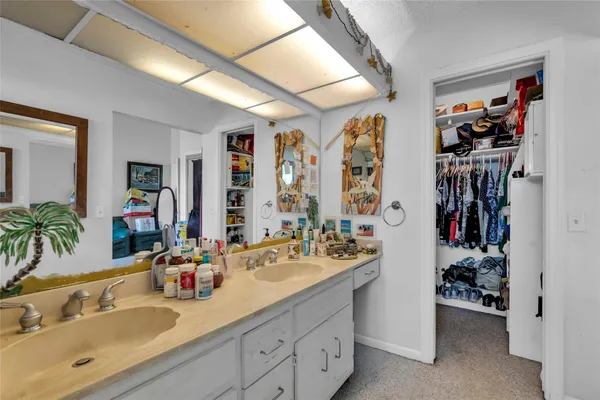 a en suite bathroom with a double vanity sink and a large mirror