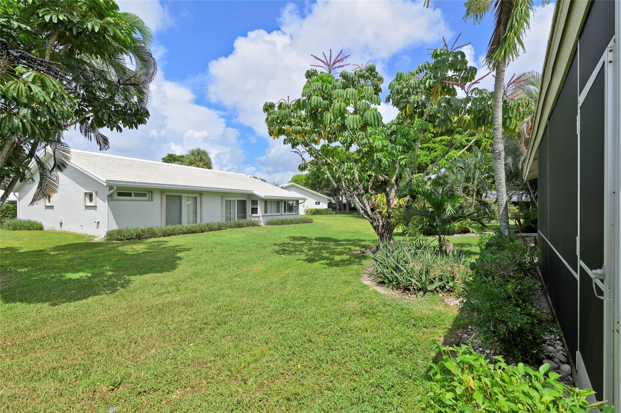 22349 Treetop Circle Boca Raton, FL 33433 - Photo 23 of 36 a front view of a house with garden