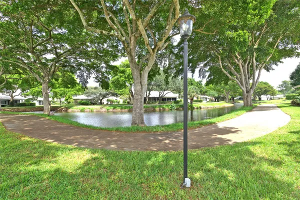 a backyard of a house with lots of green space and fountain