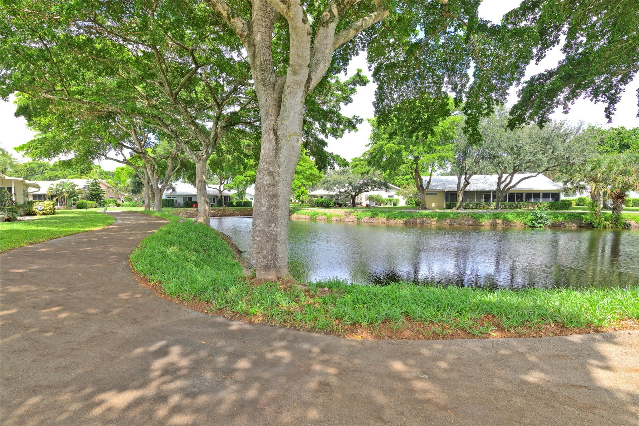 22349 Treetop Circle Boca Raton, FL 33433 - Photo 31 of 36 a lake view with a garden