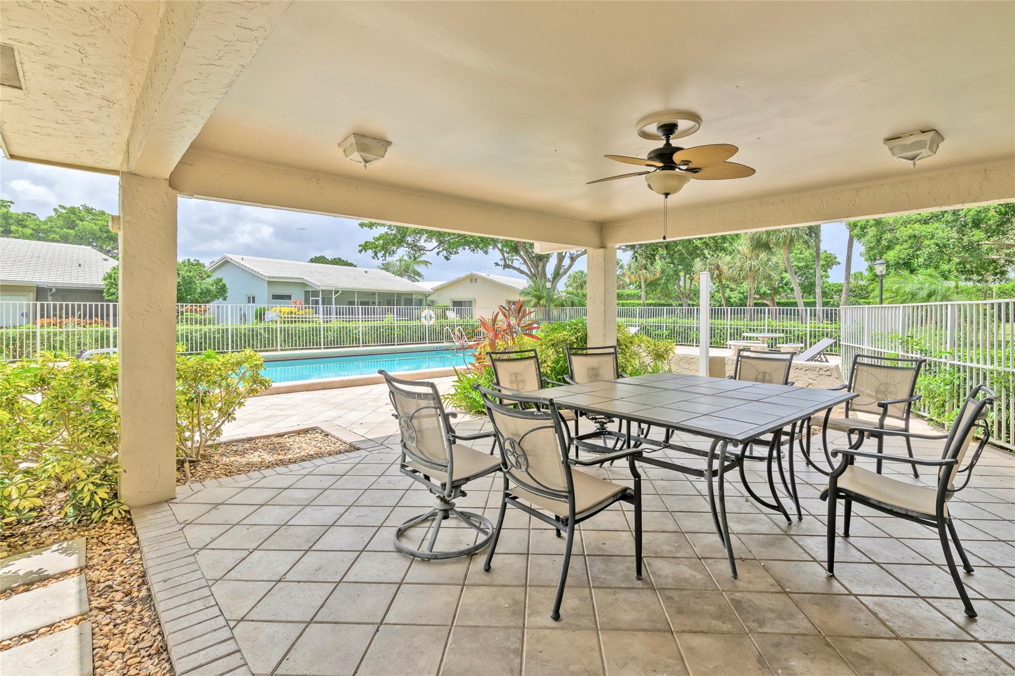 22349 Treetop Circle Boca Raton, FL 33433 - Photo 34 of 36 a view of a porch with furniture and a yard