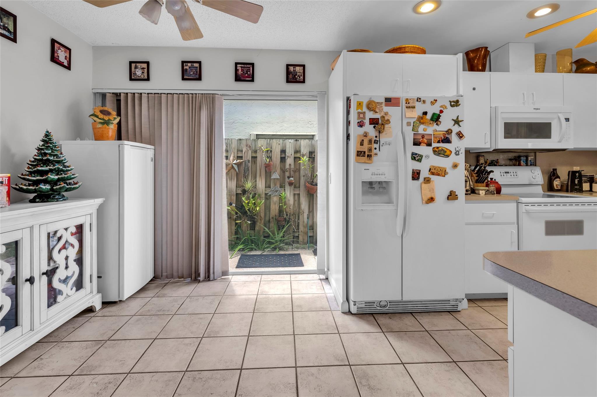 22349 Treetop Circle Boca Raton, FL 33433 - Photo 9 of 36 a kitchen with stainless steel appliances a refrigerator and a stove top oven