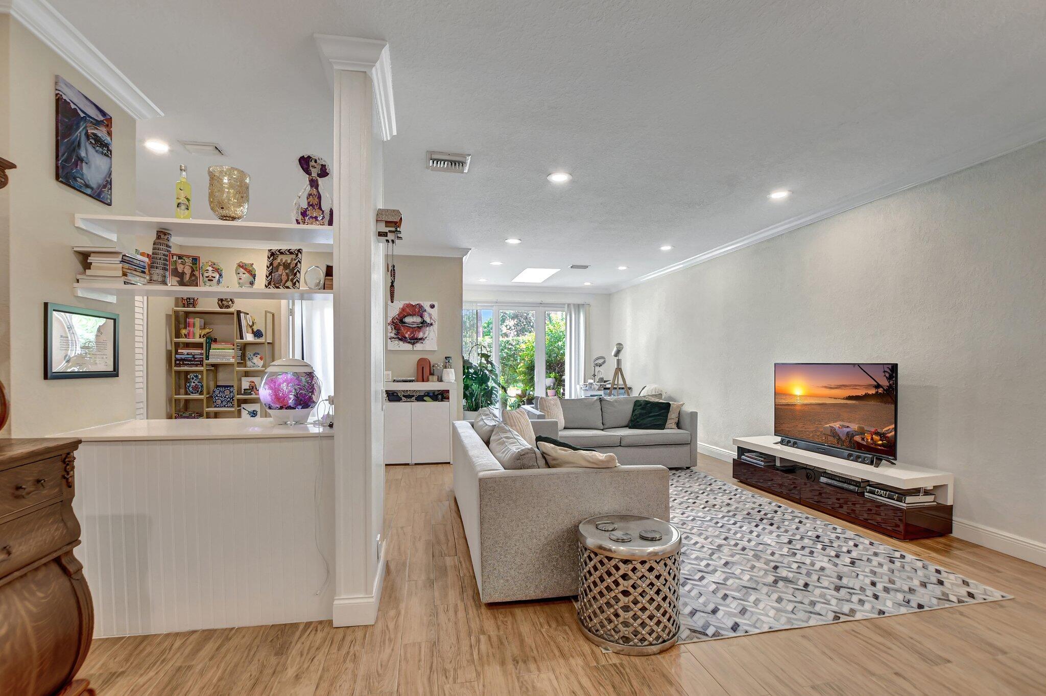 6682 Via Regina Boca Raton, FL 33433 - Photo 26 of 46 a living room with furniture and a flat screen tv