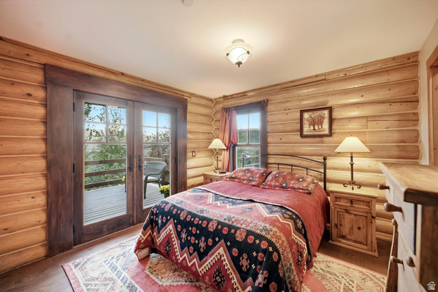 12465 Bone Road Kamas, UT 84036 - Photo 35 of 63 Wood-finish wall paneling, wood-finish flooring, glass-paned double doors, wood-frame window, and a ceiling-mounted light fixture