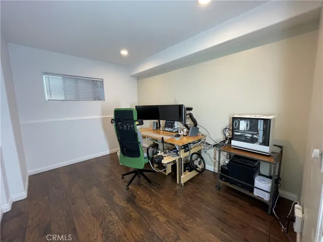 a view of a workspace with furniture and wooden floor