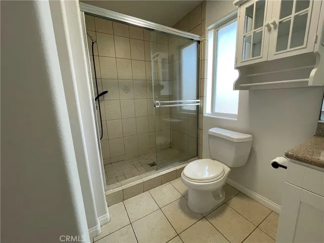 a bathroom with a toilet and a shower