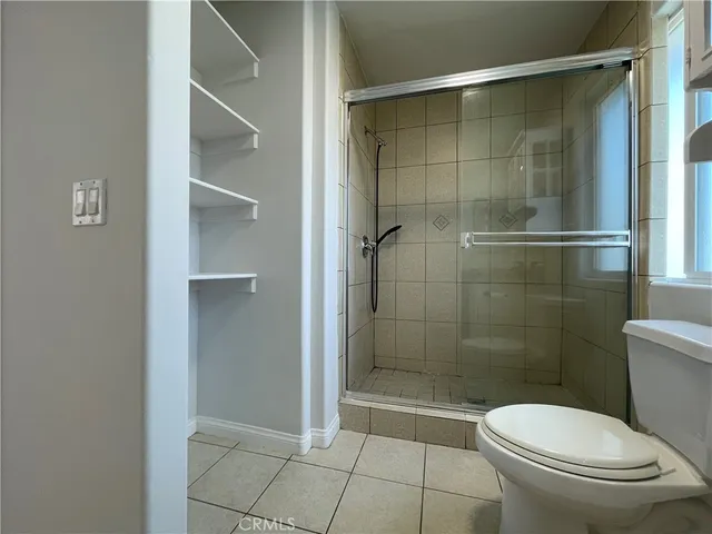 a bathroom with a toilet and a shower