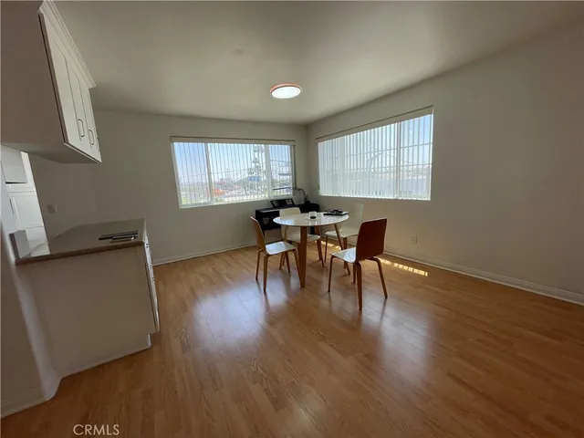 a dining room with furniture and wooden floor