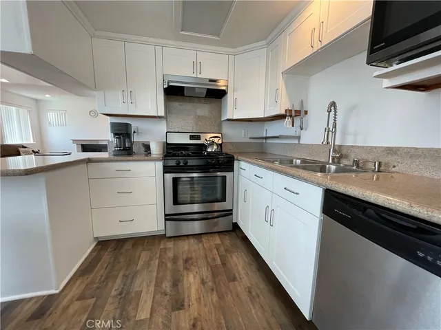 a kitchen with a sink stove and cabinets