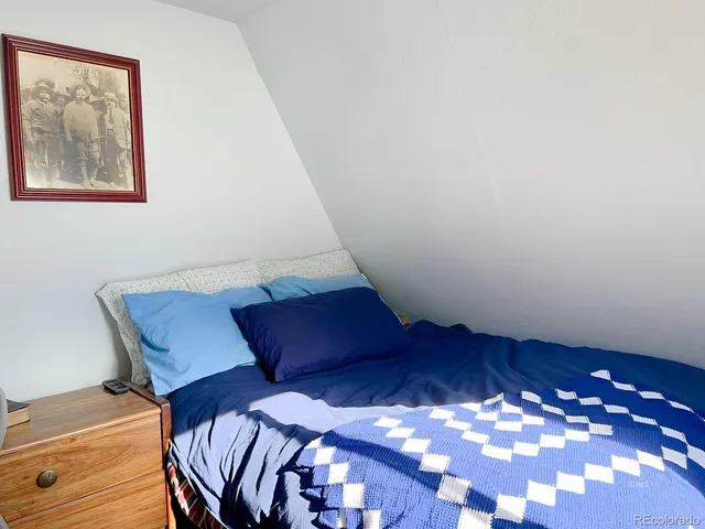 a view of workspace room with furniture and lamp