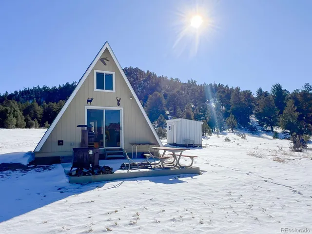 a view of a roof deck with chair and tables