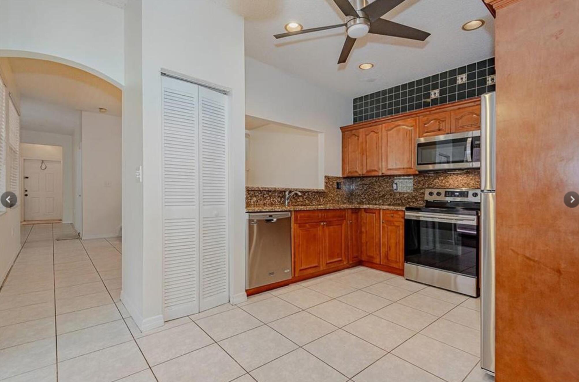 4025 Tree Top Road Cooper City, FL 33026 - Photo 4 of 4 a kitchen with granite countertop a stove a sink and a refrigerator