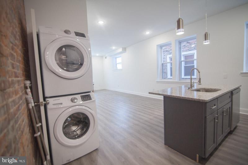 1829 North 33rd Street, Unit 1 Philadelphia, PA 19121 - Photo 7 of 9 a view of a kitchen with a washer and dryer