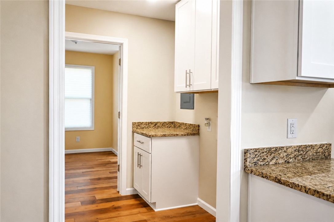 605 Hampton Street Iva, SC 29655 - Photo 13 of 16 Granite counters and hardwood floors elevate this practical and functional utility space.