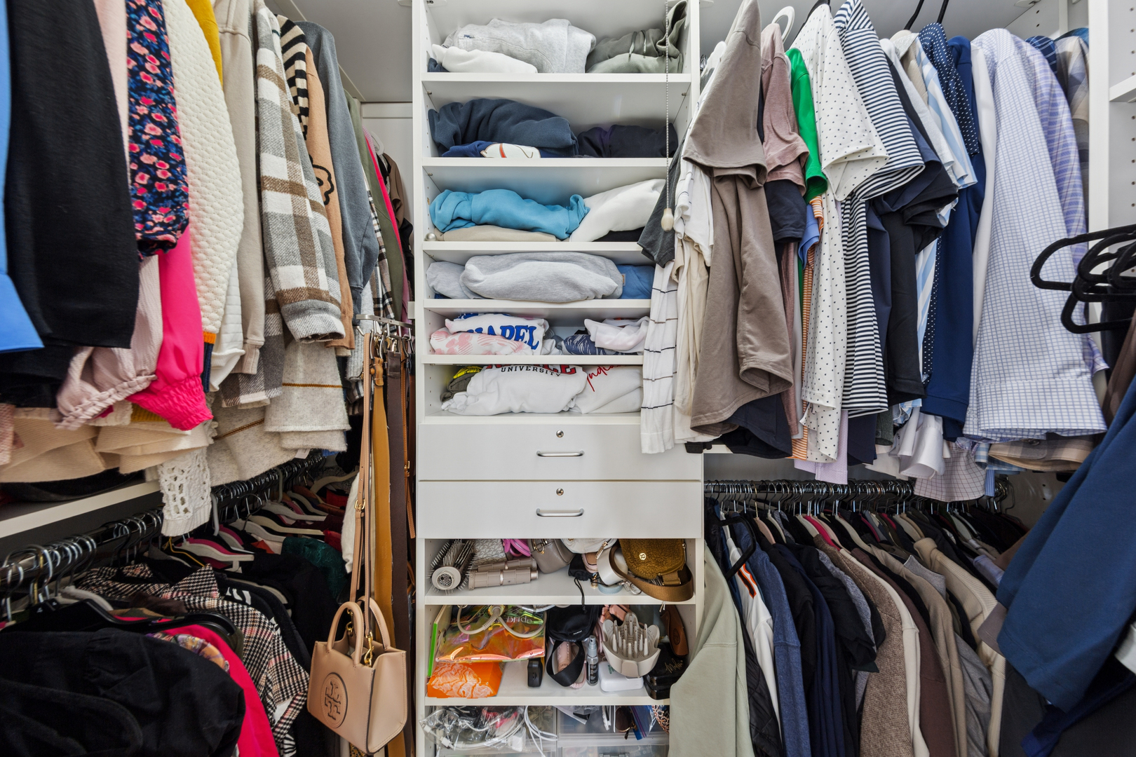 1030 North State Street, Unit 10K Chicago, IL 60610 - Photo 13 of 17 a view of walk in closet with clothes and shoes