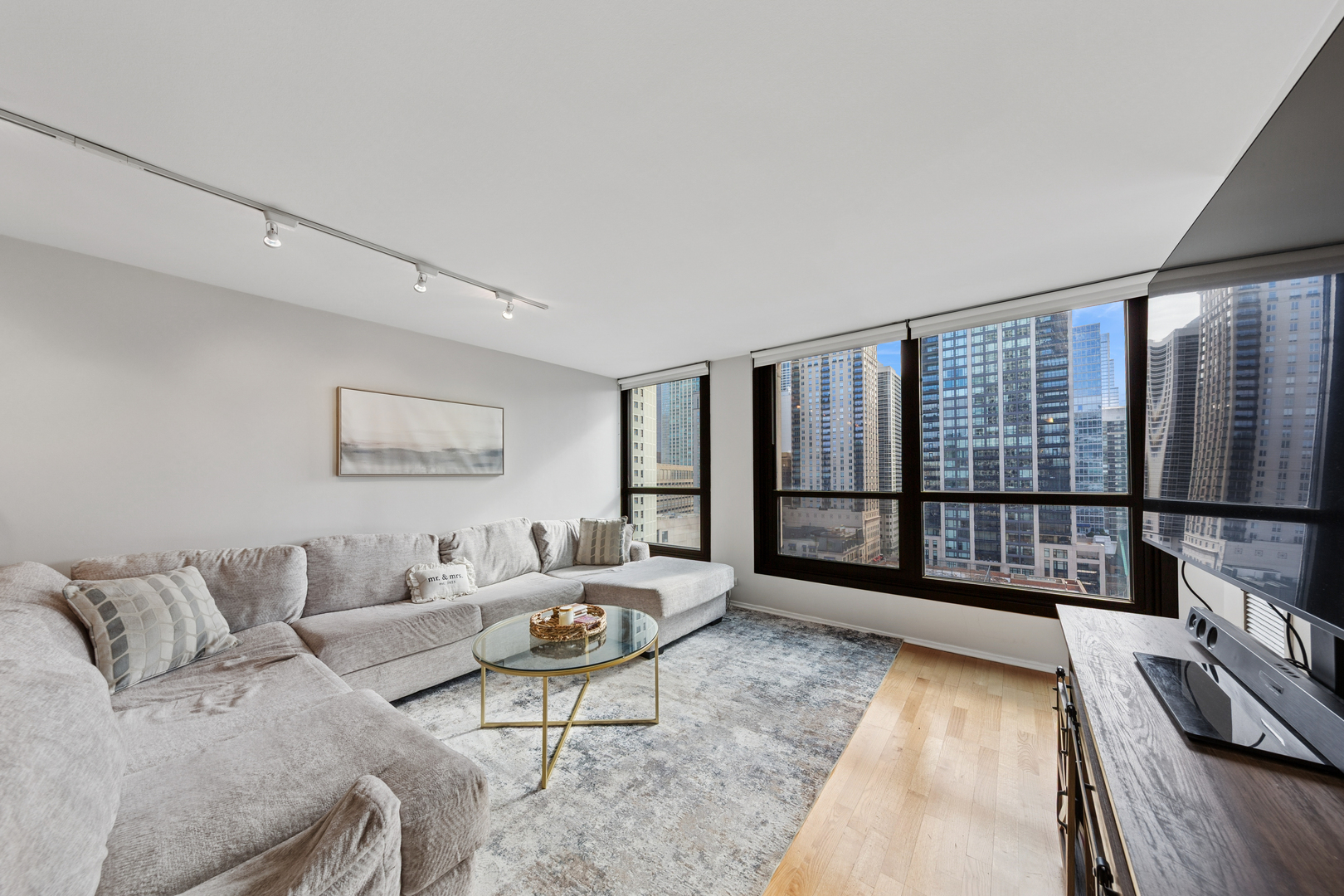 1030 North State Street, Unit 10K Chicago, IL 60610 - Photo 4 of 17 a living room with furniture large window and wooden floor