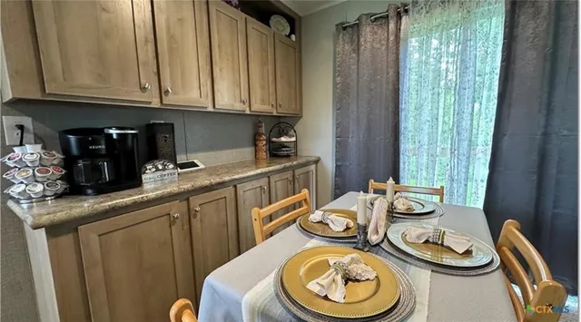 a kitchen with a sink a stove and a wooden cabinets