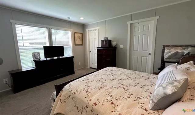 a bedroom with a bed and a television