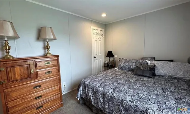 a bedroom with a bed and a lamp