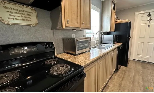 a kitchen with granite countertop a stove and a refrigerator