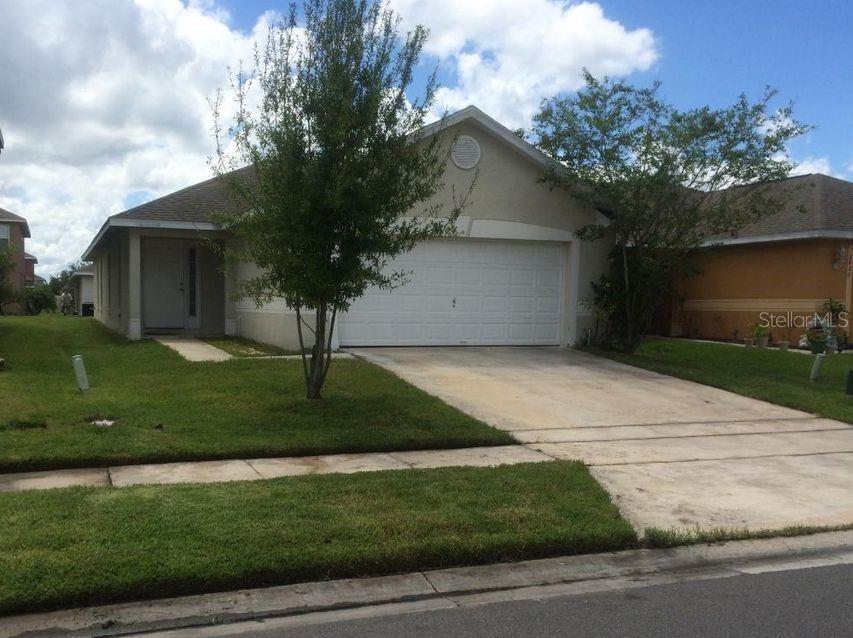 2428 Ruddenstone Way Kissimmee, FL 34744 - Photo 1 of 1 a front view of a house with garden