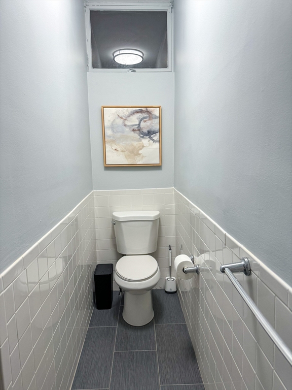 636 Washington Street, Unit 1 Brookline, MA 02446 - Photo 14 of 17 a bathroom with a toilet and a vanity