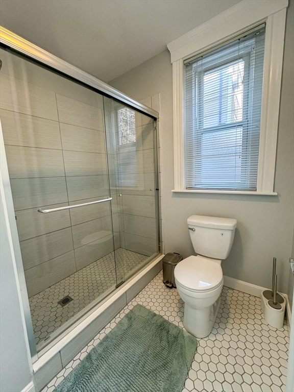 636 Washington Street, Unit 1 Brookline, MA 02446 - Photo 15 of 17 a bathroom with a toilet sink and shower