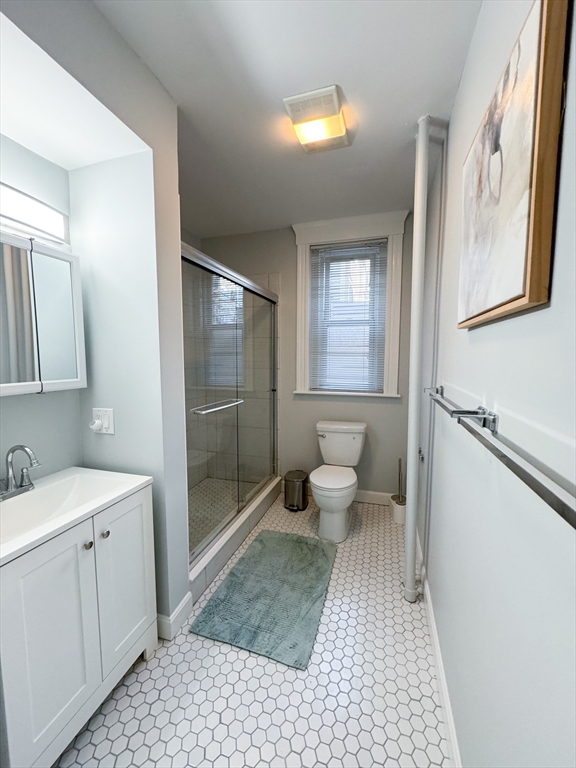 636 Washington Street, Unit 1 Brookline, MA 02446 - Photo 16 of 17 a bathroom with a sink toilet and shower
