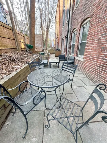 a backyard of a house with table and chairs