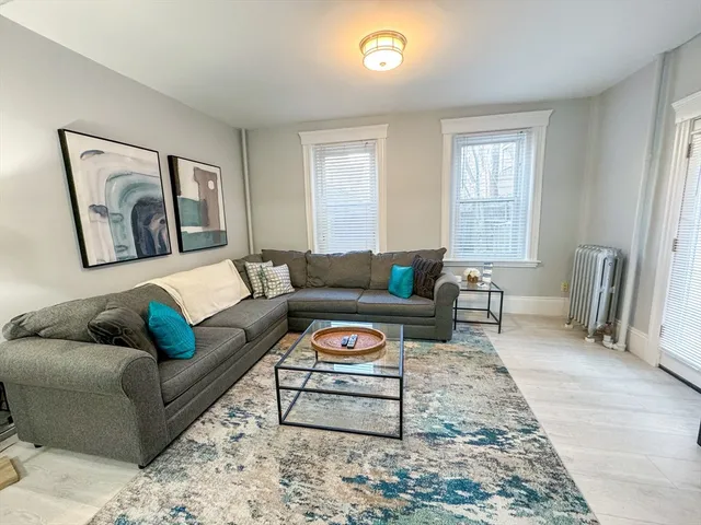 a living room with furniture and a rug