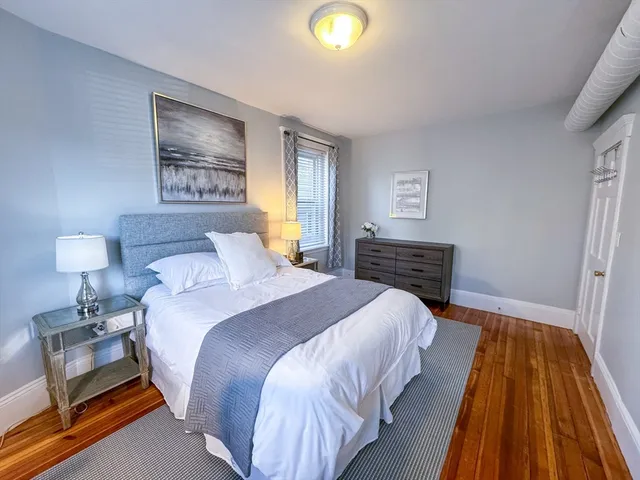 a bedroom with bed and night stand