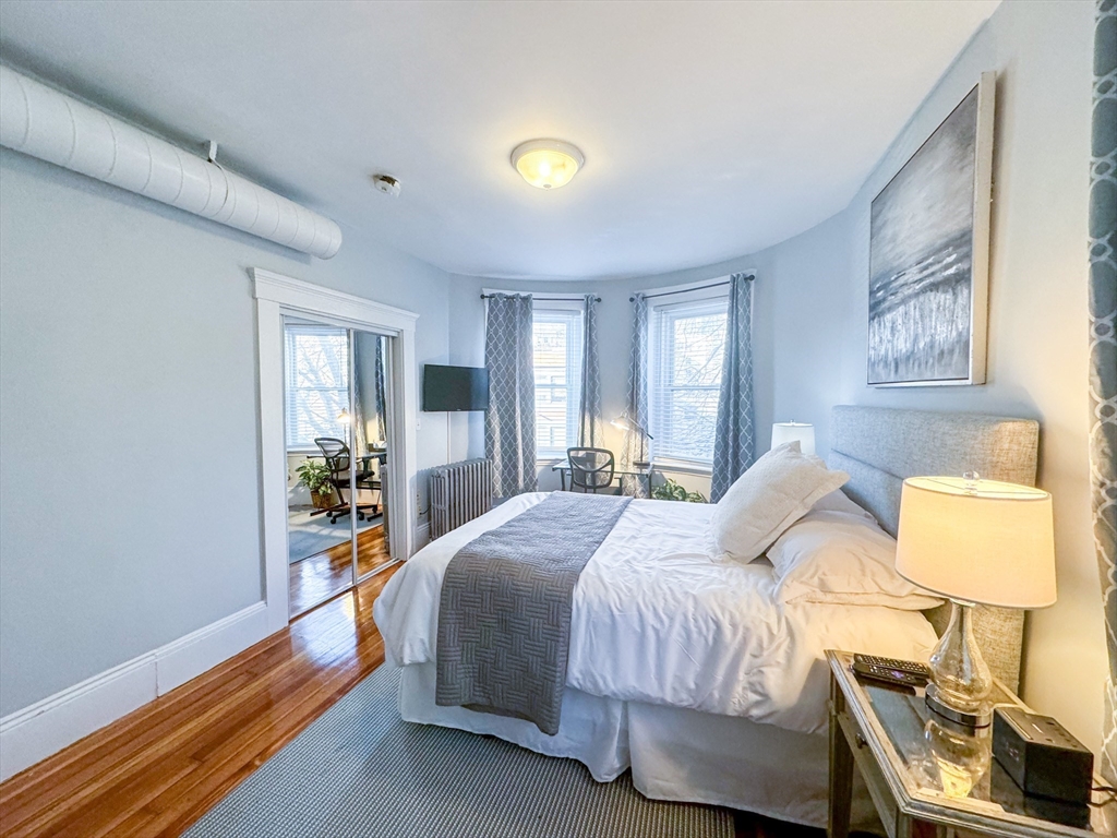 636 Washington Street, Unit 1 Brookline, MA 02446 - Photo 9 of 17 a bedroom with a bed and a window