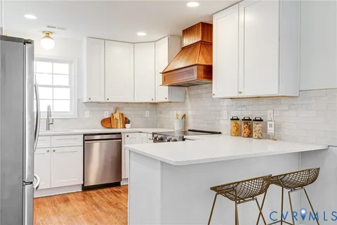 a kitchen with appliances cabinets and a sink