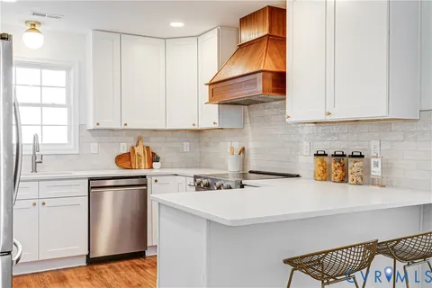 a stove top oven sitting inside of a kitchen