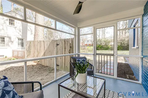 a view of a yard in front of a house with large trees
