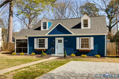 a front view of a house with a yard and seating space